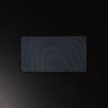 Midnight Contour desk mat, brass contour lines on navy, 12 by 22 inches