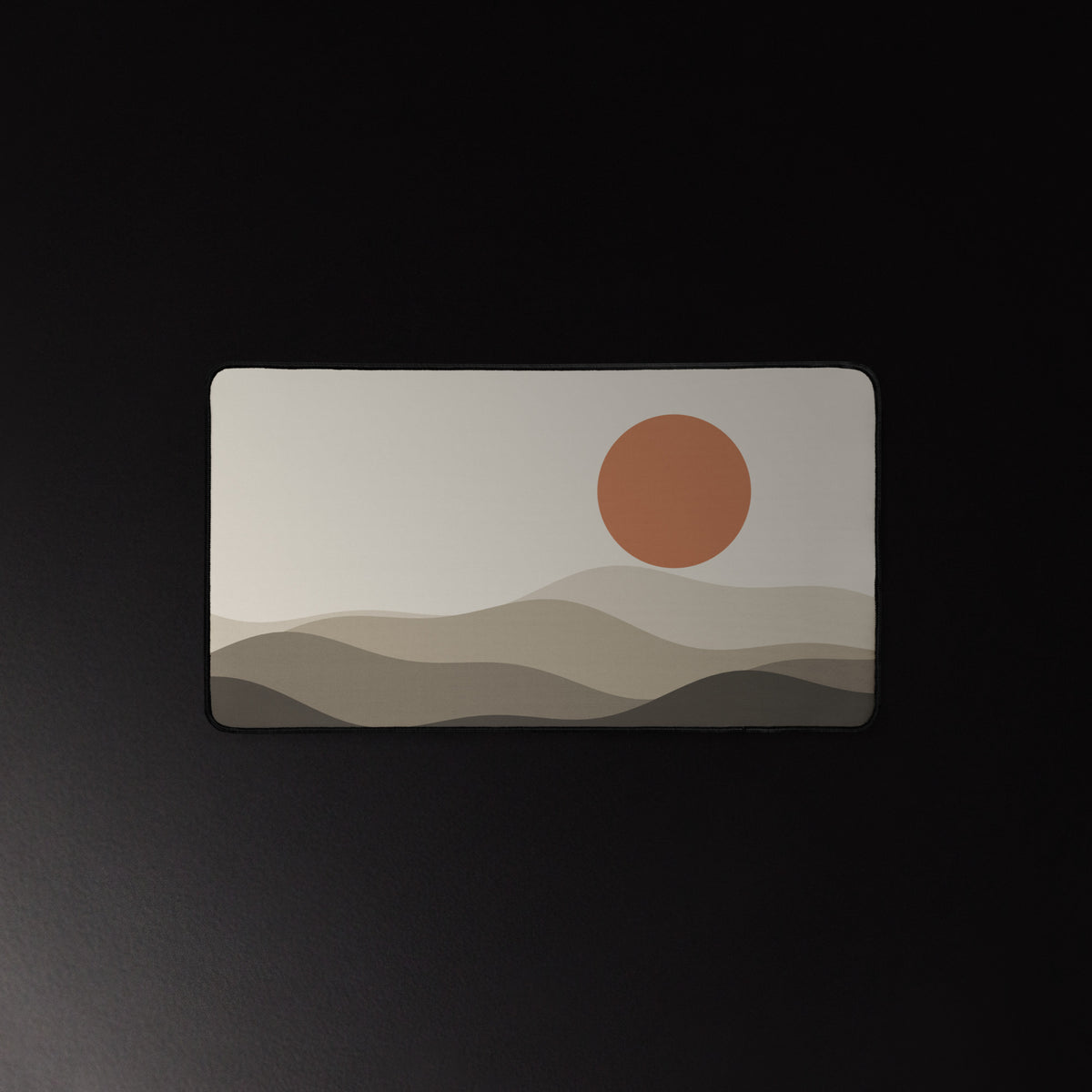 Paper Hills desk mat, terracotta sun over layered hills, 12 by 22 inches