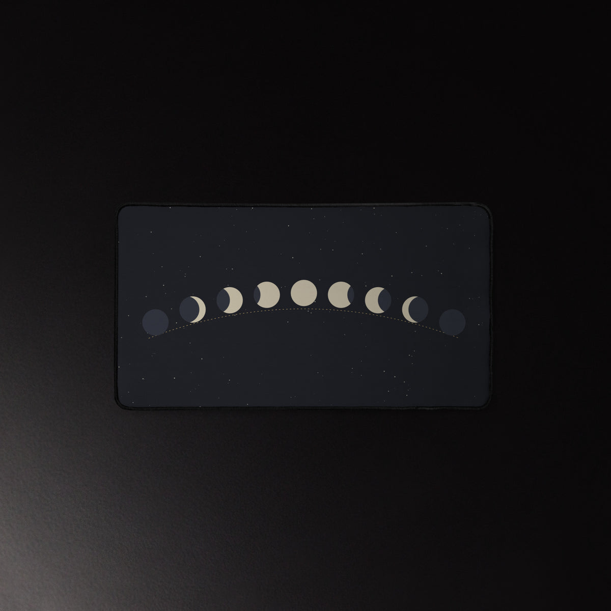 Moon Arc desk mat, golden moon phase arc on a star field, 12 by 22 inches