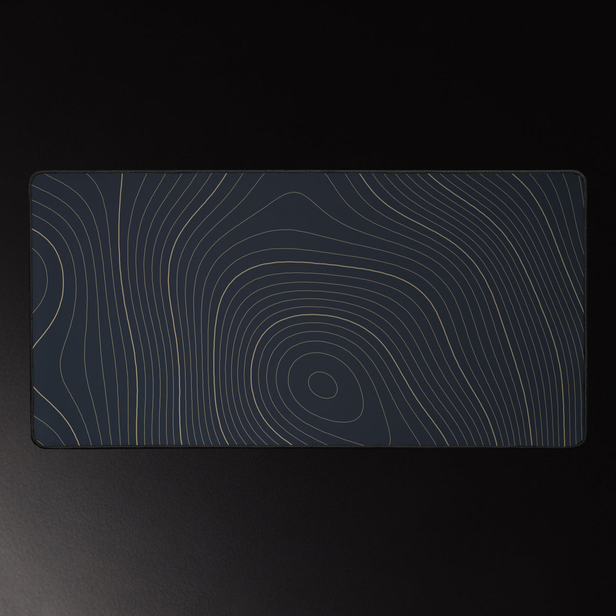 Midnight Contour desk mat, brass contour lines on navy, 16 by 32 inches