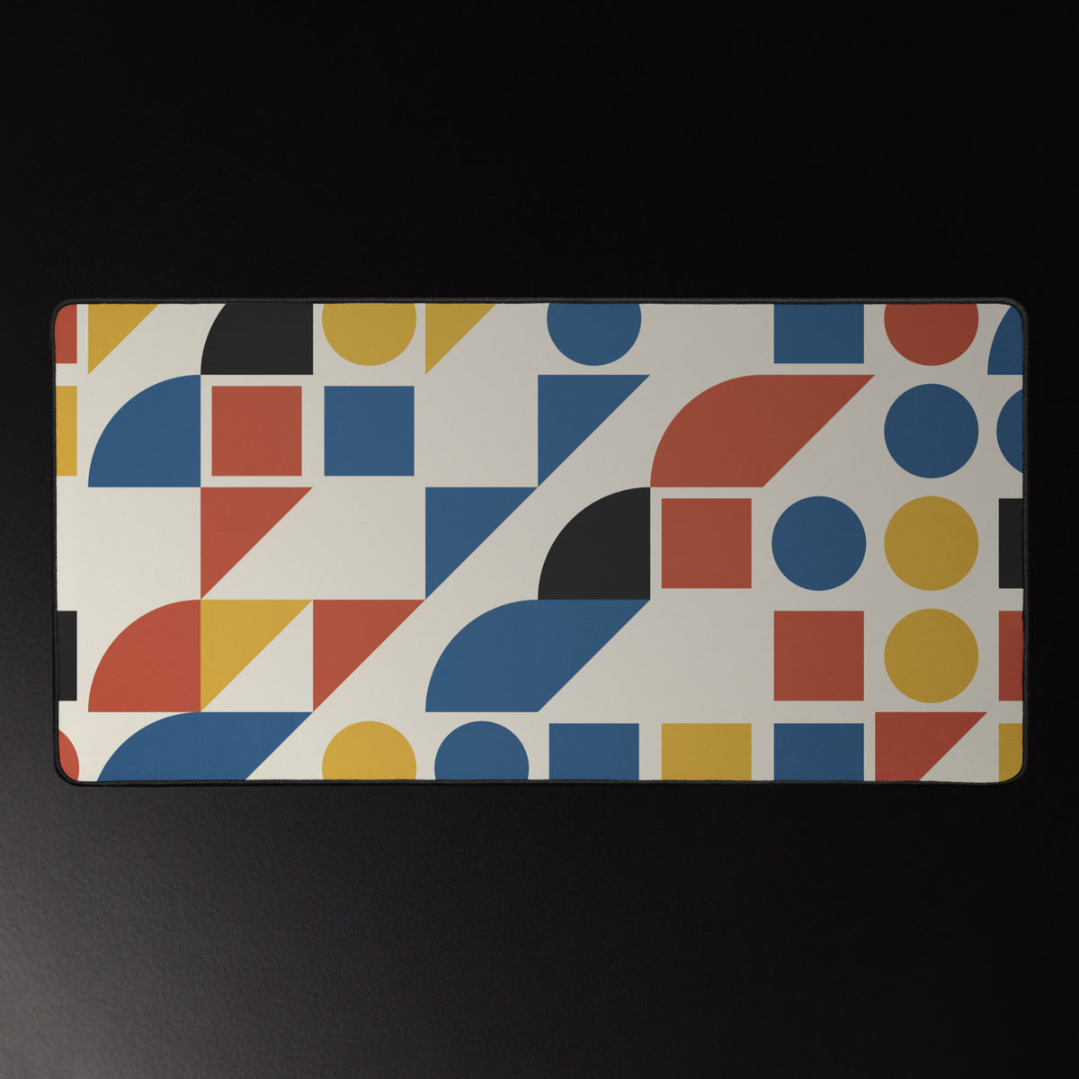 Bauhaus Grid desk mat, mustard, brick red and cobalt shapes on cream, 16 by 32 inches