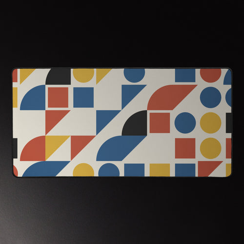 Bauhaus Grid desk mat, mustard, brick red and cobalt shapes on cream, 16 by 32 inches