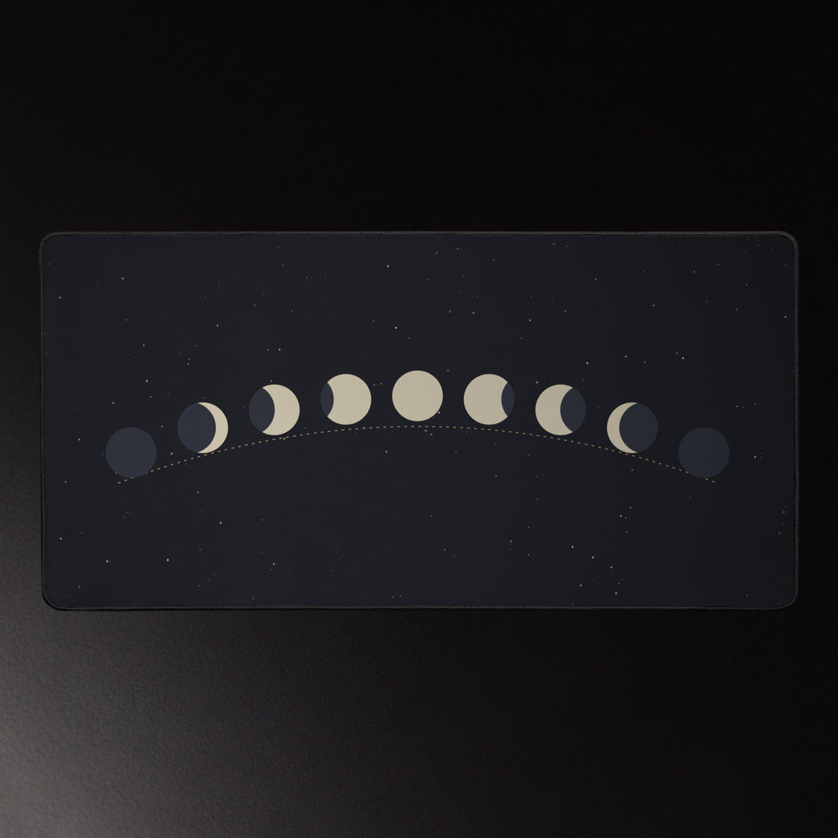 Moon Arc desk mat, golden moon phase arc on a star field, 16 by 32 inches